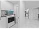 Clean laundry room with modern appliances and adjacent hallway leading to the kitchen at 125 Island Way # 404, Clearwater Beach, FL 33767
