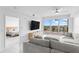Living room with tile floors, neutral colors, and a view of the water from the balcony at 125 Island Way # 404, Clearwater Beach, FL 33767