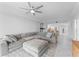 Bright living room with sectional sofa, a ceiling fan, and tile floors at 125 Island Way # 404, Clearwater Beach, FL 33767