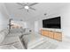 Living room boasts a large television, modern furniture, and tile floors at 125 Island Way # 404, Clearwater Beach, FL 33767