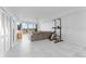 Bright living room with tile floors, ceiling fan, sliding glass doors to balcony and comfortable seating at 125 Island Way # 404, Clearwater Beach, FL 33767