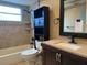 Well-lit bathroom featuring a shower/tub combo, vanity with dark wood cabinets and modern fixtures at 12607 Blackberry Row, Hudson, FL 34667