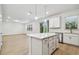 The open-concept kitchen, featuring quartz counters, stainless appliances, and island at 12614 Glenn Creek Dr, Riverview, FL 33569