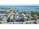 Aerial view of waterfront condos near bridge, showcasing a pool and nearby amenities at 131 Bluff View Dr # 409, Belleair Bluffs, FL 33770