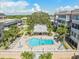Overhead view of the community pool with lounge chairs and lush tropical landscaping at 131 Bluff View Dr # 409, Belleair Bluffs, FL 33770