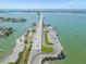 Panoramic aerial view of bridge leading to waterfront with scenic views of ocean and nearby land at 131 Bluff View Dr # 409, Belleair Bluffs, FL 33770