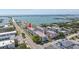 A sunny aerial view of a condominium complex near a bridge and waterfront with boats docked nearby at 131 Bluff View Dr # 409, Belleair Bluffs, FL 33770