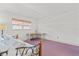 Bedroom with purple carpet, window and desk area at 131 Bluff View Dr # 409, Belleair Bluffs, FL 33770