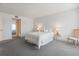 Bright bedroom with neutral carpet and a bed with pillows at 131 Bluff View Dr # 409, Belleair Bluffs, FL 33770