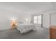 Bright bedroom with neutral carpet and a bed with pillows at 131 Bluff View Dr # 409, Belleair Bluffs, FL 33770