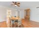 Charming dining room with hardwood floors, a ceiling fan, and a rustic china cabinet at 131 Bluff View Dr # 409, Belleair Bluffs, FL 33770
