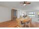 Well lit dining room with a wooden dining table, a ceiling fan, and a glass front china cabinet at 131 Bluff View Dr # 409, Belleair Bluffs, FL 33770