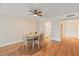 View of the dining room featuring hardwood floors, wainscotting, wallpaper, and a ceiling fan at 131 Bluff View Dr # 409, Belleair Bluffs, FL 33770