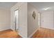 Hallway with a view of the kitchen and an entry door to the home at 131 Bluff View Dr # 409, Belleair Bluffs, FL 33770