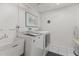 Laundry room with washer, dryer, utility sink, and ample space at 131 Bluff View Dr # 409, Belleair Bluffs, FL 33770