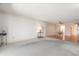 Bright living room with neutral carpet and a dining area to the right at 131 Bluff View Dr # 409, Belleair Bluffs, FL 33770