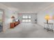Bright living room with neutral carpet, balcony and large windows to let in lots of light at 131 Bluff View Dr # 409, Belleair Bluffs, FL 33770