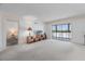 Bright living room with neutral carpet and balcony to let in lots of light, next to bedroom at 131 Bluff View Dr # 409, Belleair Bluffs, FL 33770