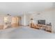 Bright living room with neutral carpet next to dining room. TV stand included at 131 Bluff View Dr # 409, Belleair Bluffs, FL 33770