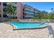 Community pool surrounded by lounge chairs in a bright and sunny setting at 131 Bluff View Dr # 409, Belleair Bluffs, FL 33770
