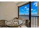 Ocean view from the screened in balcony with table and seating for relaxing at 14900 Gulf Blvd # 304, Madeira Beach, FL 33708