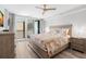 Bright bedroom with a balcony access, a large bed, and modern decor at 14900 Gulf Blvd # 304, Madeira Beach, FL 33708