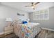 Bedroom featuring shuttered windows, light walls, hard flooring, and a nautical themed comforter at 14900 Gulf Blvd # 304, Madeira Beach, FL 33708