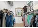 Walk-in closet featuring lots of hanging storage, and laminate flooring at 14900 Gulf Blvd # 304, Madeira Beach, FL 33708