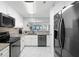 Sleek kitchen featuring stainless steel appliances, white cabinetry, and granite countertops at 14900 Gulf Blvd # 304, Madeira Beach, FL 33708