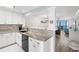 Modern kitchen with stainless steel appliances, granite countertops, and an open design at 14900 Gulf Blvd # 304, Madeira Beach, FL 33708