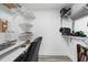 Home office featuring a desk with a rolling chair, shelving, and laminate flooring at 14900 Gulf Blvd # 304, Madeira Beach, FL 33708