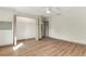 Bedroom with hardwood floors, and a closet with open doors for accessible storage at 1510 Lakeside Dr, Dunedin, FL 34698