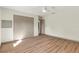 A bright bedroom features hardwood floors and a large closet for storage at 1510 Lakeside Dr, Dunedin, FL 34698