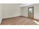 A clean bedroom with wood-look floors and a door to the outside at 1510 Lakeside Dr, Dunedin, FL 34698