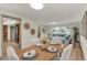 Dining area with a wooden table set, seamlessly flowing into the living area, bright and inviting atmosphere at 1510 Lakeside Dr, Dunedin, FL 34698