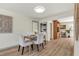 Light and airy dining room featuring a wooden table, white chairs, and seamless connection to a small office space at 1510 Lakeside Dr, Dunedin, FL 34698