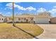 Charming single-story home with well-maintained lawn and inviting curb appeal on a sunny day at 1510 Lakeside Dr, Dunedin, FL 34698