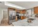 Bright kitchen features stainless steel appliances, light wood cabinets, and marble countertops at 1510 Lakeside Dr, Dunedin, FL 34698