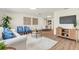 Open-concept living area with hardwood floors flowing into the dining area, creating a warm atmosphere at 1510 Lakeside Dr, Dunedin, FL 34698