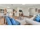 Open living area with modern furnishings, light wood floors, and a comfortable seating arrangement with a TV at 1510 Lakeside Dr, Dunedin, FL 34698