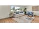 Bright living room with a large window, hardwood floors, and comfortable seating arrangement at 1510 Lakeside Dr, Dunedin, FL 34698