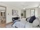 Bedroom with a neutral color scheme, light wood floors, and a seamless transition to the en-suite bathroom at 1510 Lakeside Dr, Dunedin, FL 34698