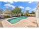 Backyard pool surrounded by a brick patio and wooden fence provides a private outdoor retreat at 1510 Lakeside Dr, Dunedin, FL 34698