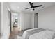 Bright bedroom featuring neutral walls, a ceiling fan, and natural light, with a walk-in closet at 1515 Greenwood N Ave, St Petersburg, FL 33704