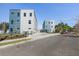 Modern townhomes displaying a striking color scheme with landscaping and inviting curb appeal at 1515 Greenwood N Ave, St Petersburg, FL 33704