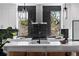 Stylish kitchen featuring a black tile backsplash, a quartz countertop, and a large window at 1515 Greenwood N Ave, St Petersburg, FL 33704