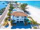 Luxurious property with a private pool, garage, beach access and lush, tropical landscaping at 20256 Gulf Blvd, Indian Shores, FL 33785