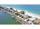 Stunning coastal home with beach access, featuring a tile roof and lush landscaping at 20256 Gulf Blvd, Indian Shores, FL 33785