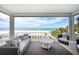 Comfortable seating on a covered balcony offers stunning ocean views at 20256 Gulf Blvd, Indian Shores, FL 33785