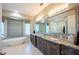 Luxurious bathroom featuring a soaking tub, double vanity, and stylish fixtures at 20256 Gulf Blvd, Indian Shores, FL 33785